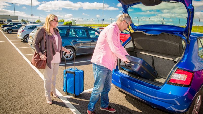 Family with suitcases at the airport about to travel abroad