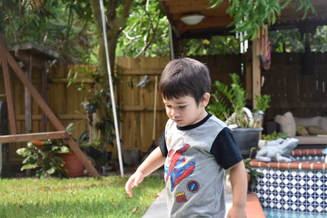 Boys playing outdoors on bikes in a garden