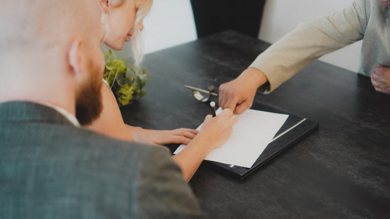 Parents reviewing paperwork together at home